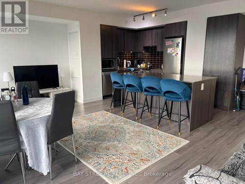 A living room with a dining table and chairs.