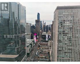 A cityscape with a building that has the word REALTOR on it.