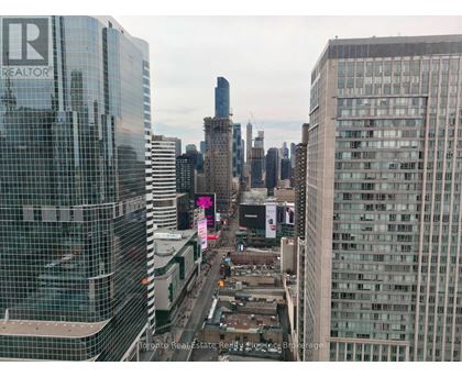 A cityscape with a building that has the word REALTOR on it.