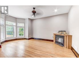 A living room with a wood floor and a fireplace.