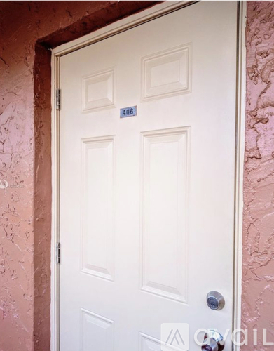 A white door with a blue sign on it.