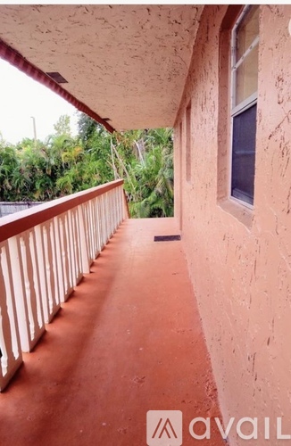 A balcony with a railing and a window.