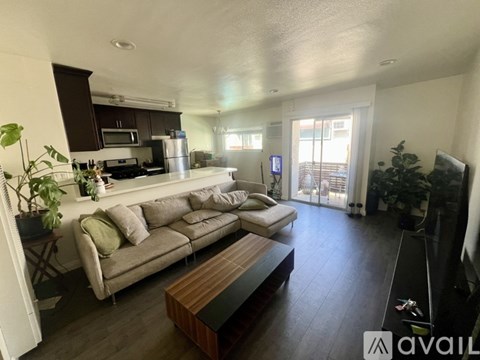 A living room with a grey couch and a wooden coffee table.