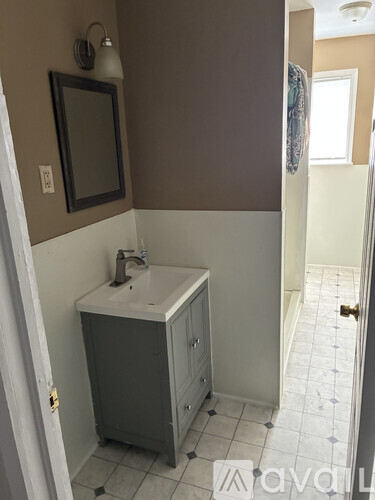 A bathroom with a sink and a mirror on the wall.