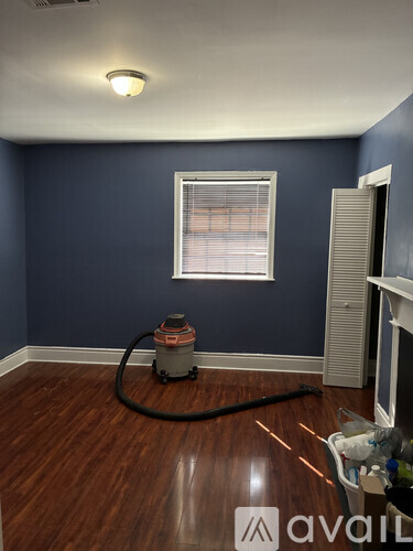 A room with a vacuum cleaner on the floor.
