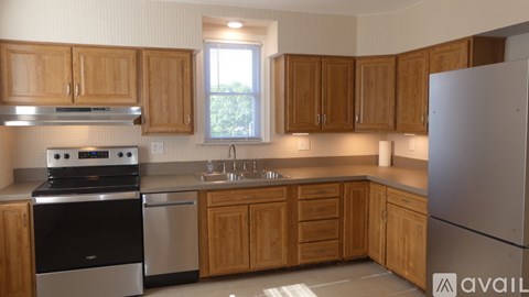 A kitchen with wooden cabinets and stainless steel appliances.