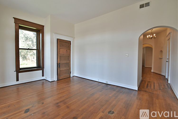 A room with wooden floors and white walls.