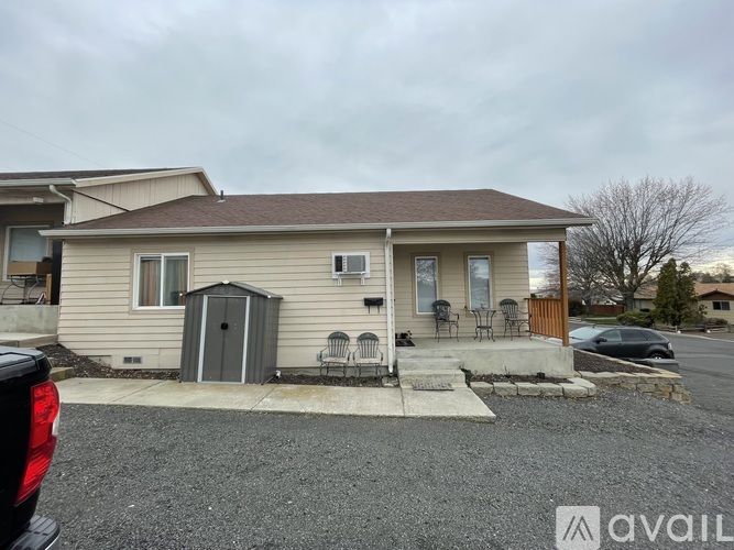 A house with a brown roof and a garage door is available for rent.