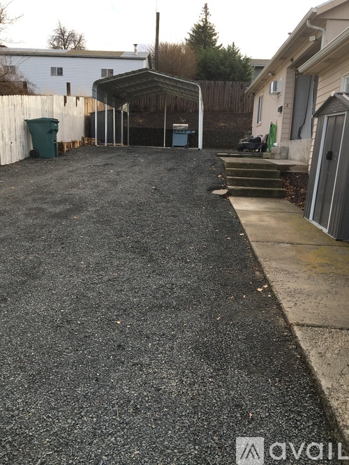 A gravel driveway leads to a garage.