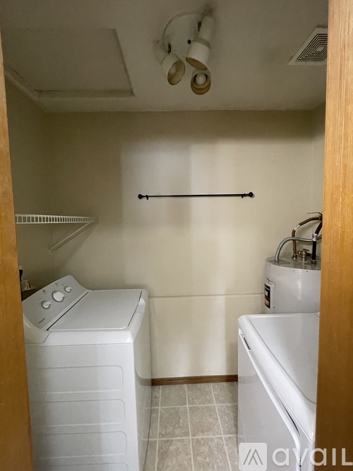 A small laundry room with a washer and dryer.