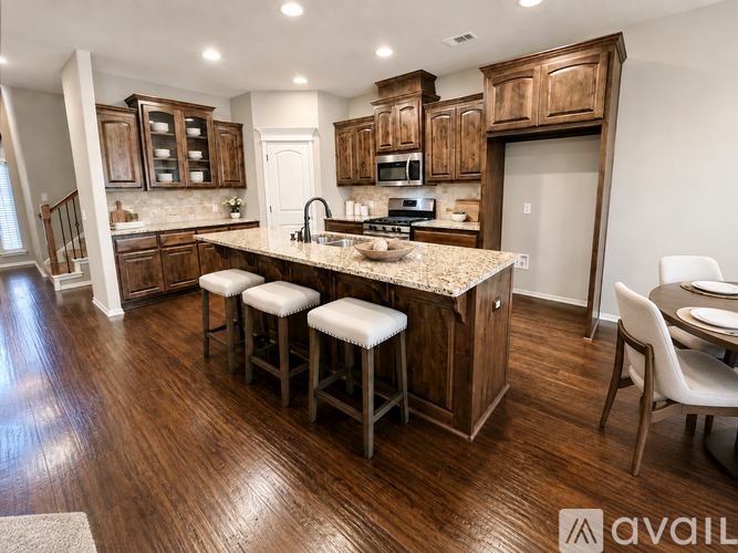 A kitchen with wooden cabinets and a granite countertop.