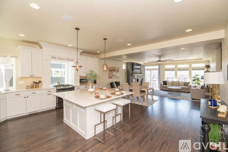 A modern kitchen with white cabinets and a center island.