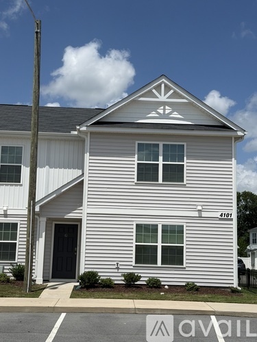 A white house with a black door and windows.