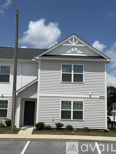 A white house with a black door and windows.