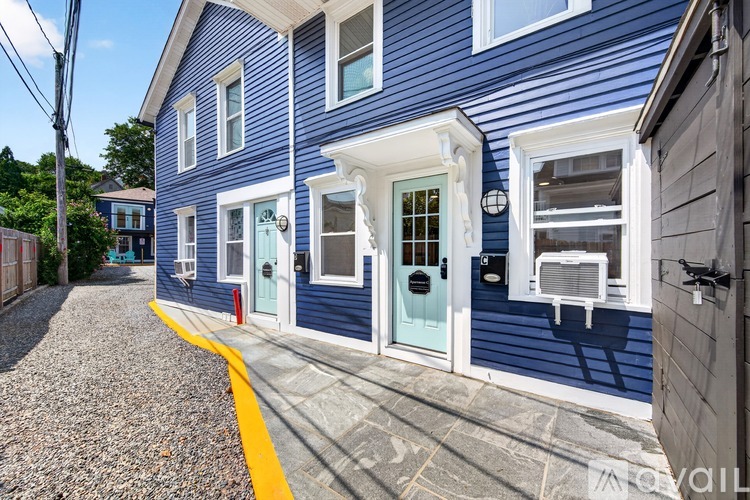A blue house with a yellow line on the sidewalk.