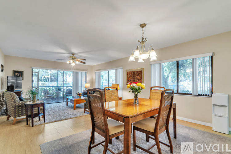 A dining room with a wooden table and chairs.