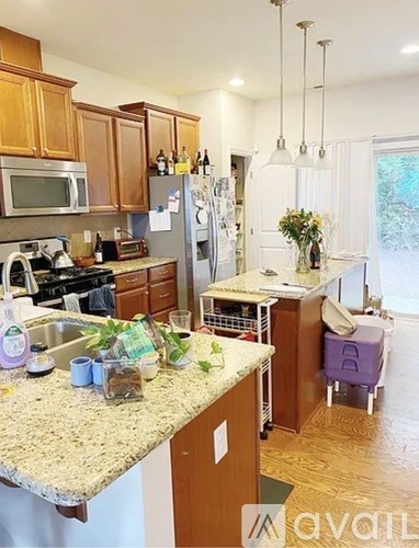 A kitchen with wooden cabinets and granite countertops.