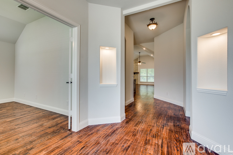 A room with wooden floors and white walls.