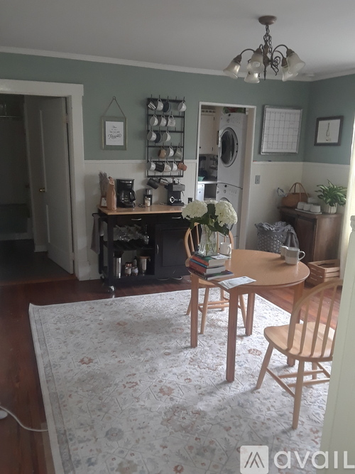 A kitchen with a table and chairs in the middle of the room.