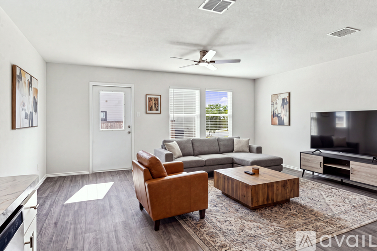A living room with a brown leather chair and a wooden coffee table.