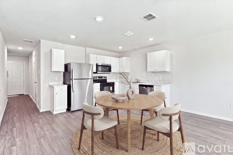 A kitchen with a table and chairs in the middle of the room.