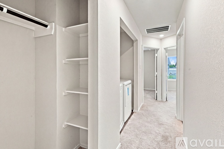 A white refrigerator with shelves inside a room with a carpeted floor.