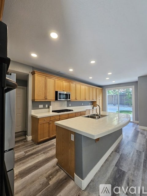 A kitchen with wooden cabinets and a white countertop.