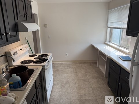 A kitchen with a stove top oven and a sink.