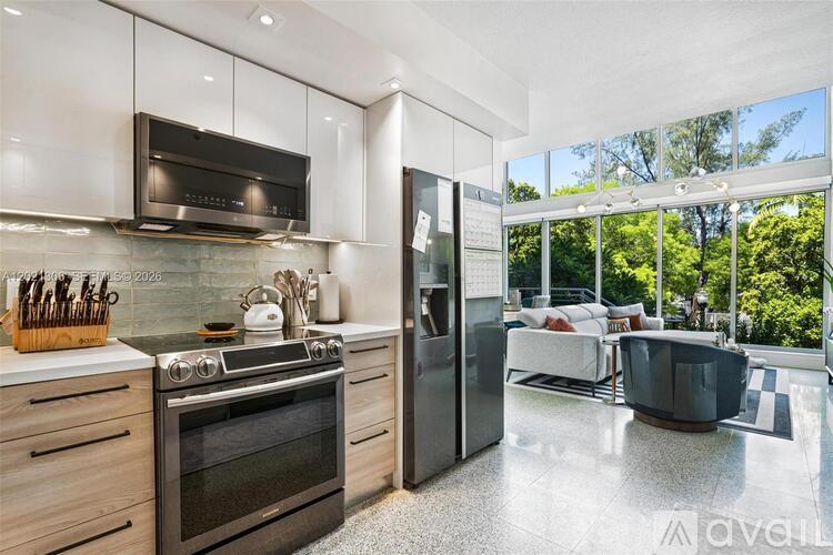 A modern kitchen with a stainless steel oven and refrigerator.