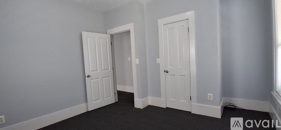 A room with two doors and a window.