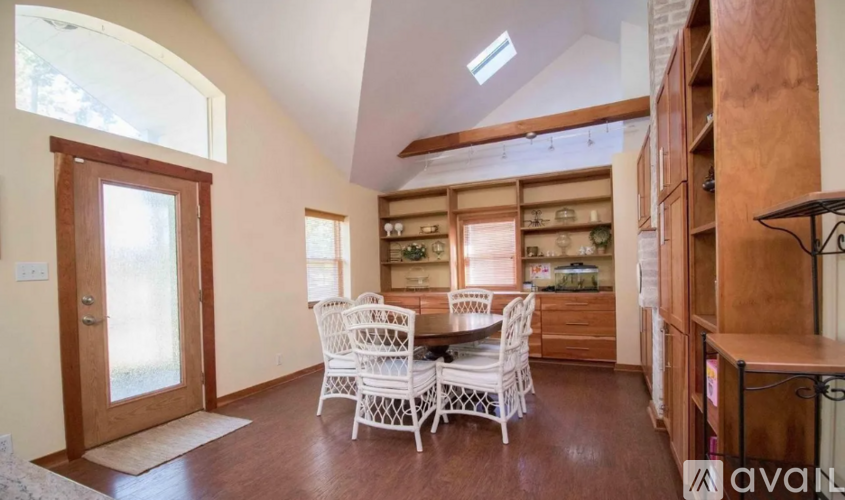 A dining room with a table and chairs is shown.