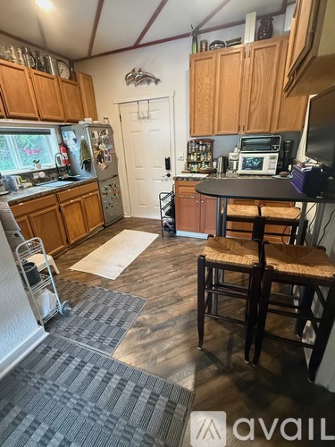 A kitchen with wooden cabinets and a refrigerator.