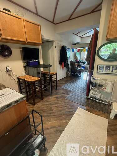 A kitchen area with wooden cabinets and a black countertop.
