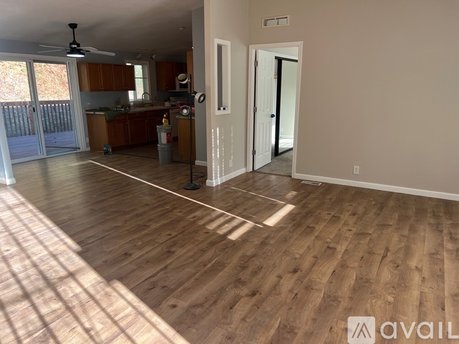 A room with wooden flooring and a ceiling fan.