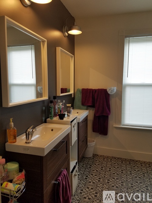 A bathroom with a white sink and a mirror above it.