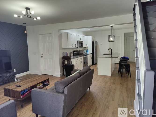 A living room with a grey couch and a wooden coffee table.