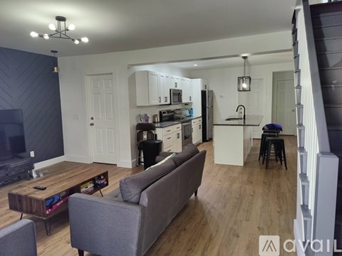 A living room with a grey couch and a wooden coffee table.