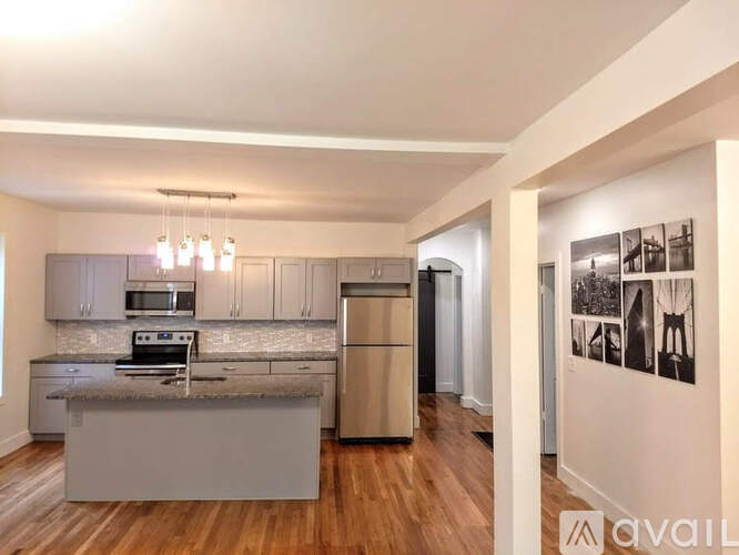 A kitchen with a refrigerator, oven, and microwave.
