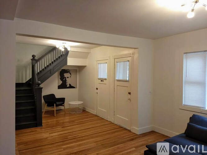A living room with a staircase and a couch.