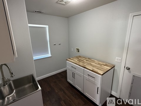 A kitchen with a sink and cabinets.