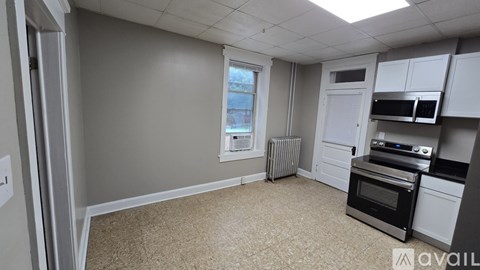 A kitchen with a stove top oven and microwave.