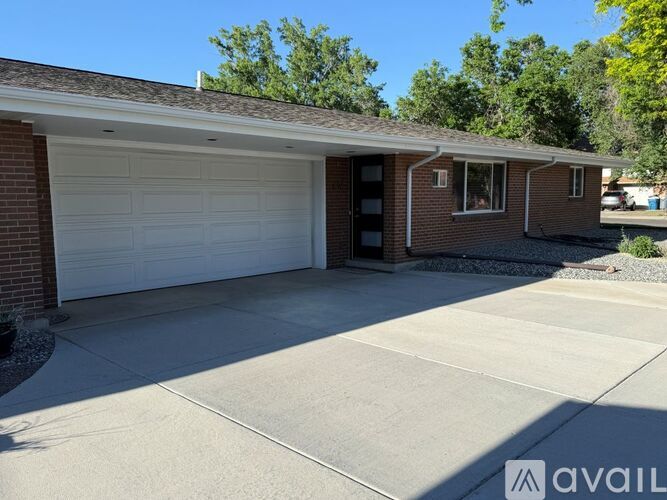 A house with a white garage door and a brown brick exterior.