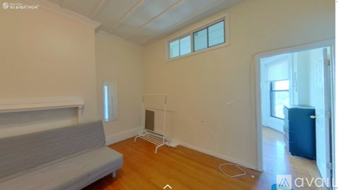 A living room with a grey sofa and a white radiator.