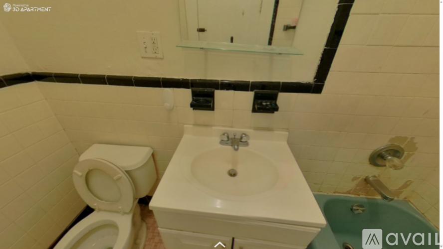 A bathroom with a toilet, sink, and mirror.