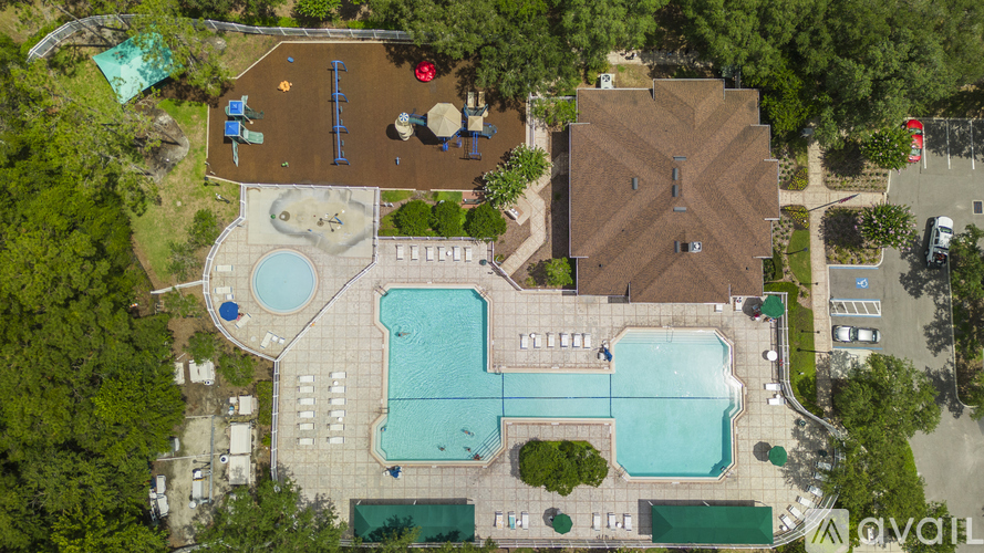 An aerial view of a resort with a large swimming pool and a water slide.