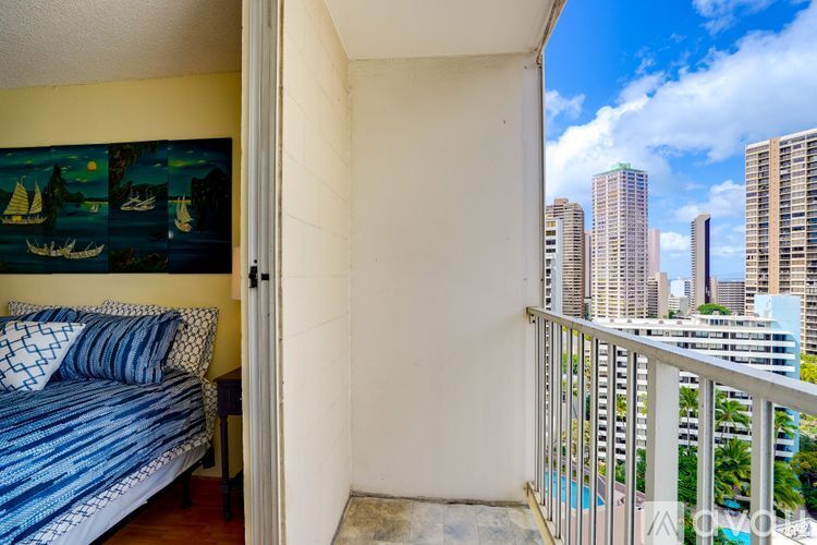 A bedroom with a bed and a view of the city.