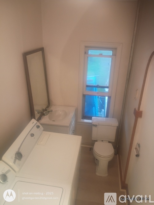 A small bathroom with a washer and dryer.