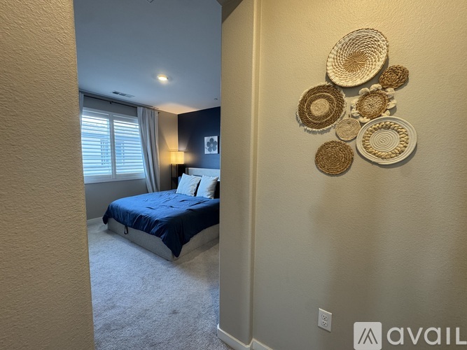 A bedroom with a bed and a wall decoration.