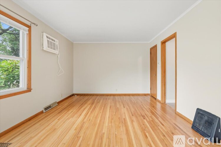 A room with wooden floors and a window.