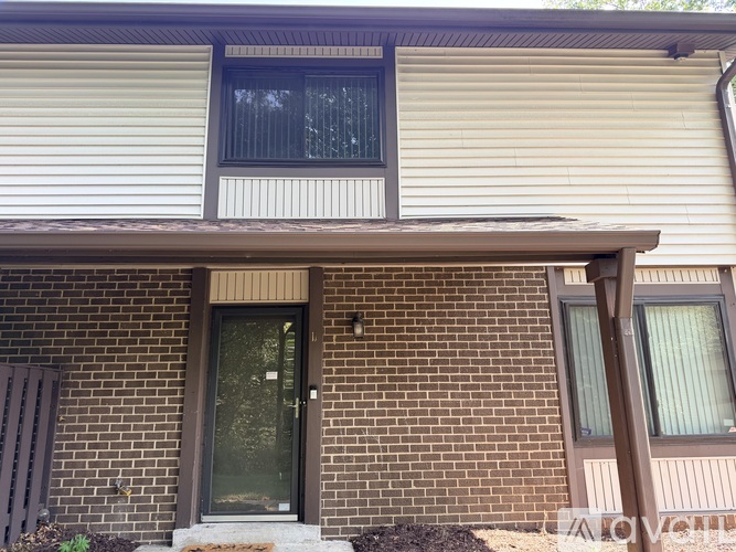 A house with a brown door and a window.